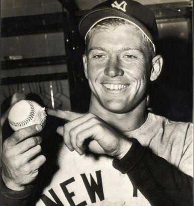 Mickey holding the historic ball after the game and pointing to the scrape that it sustained as it grazed off the metal sign on it's way out of the ballpark.